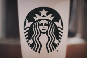 selective focus photography of black and white Starbucks cup